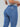 Close up of Latina woman wearing high-waisted blue butt lift jeans with 3D pockets and thick waistband.